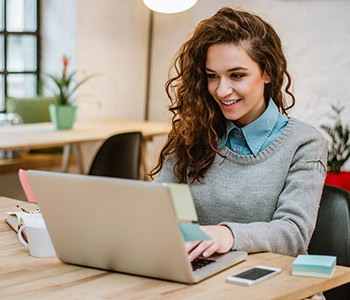 Young woman editing PDF on laptop