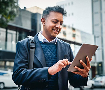 Business Man using Tablet device on-the-go