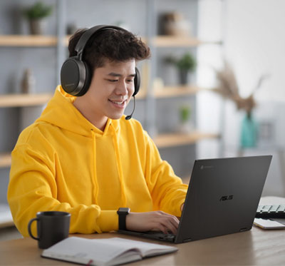 Young college student using Chromebook