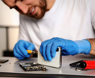 Repair Technician repairing an iPhone