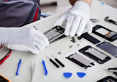 Technician repairing phone with tools on table