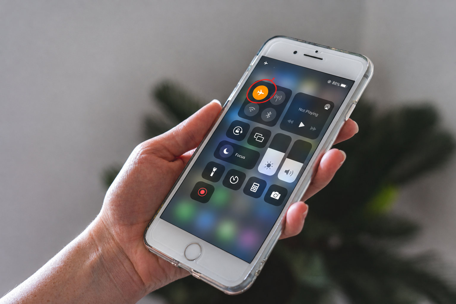Person turning Airplane Mode on and off on an iPhone